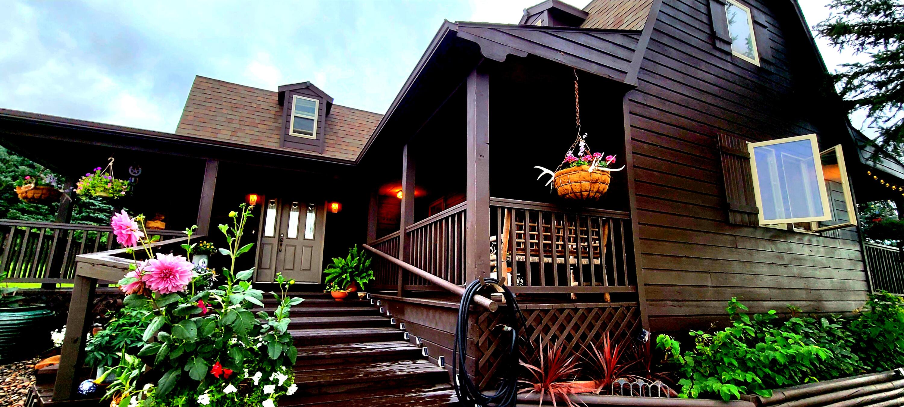 354 Bird Farm Road Sheridan, WY 82801 - Photo 11 of 51 Fresh house stain, vibrant flowers