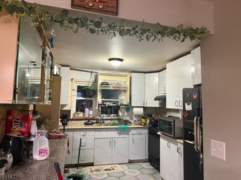39 Sunset Avenue Newark, NJ 07106 - Photo 2 of 3 a kitchen with a sink appliances and cabinets
