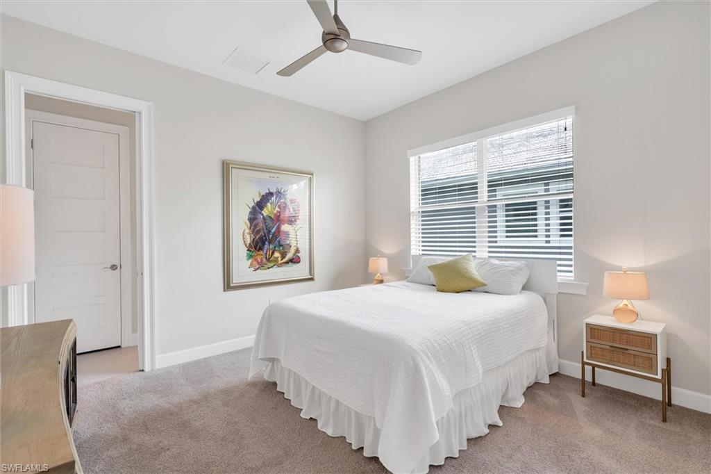 5769 Anegada Drive Naples, FL 34113 - Photo 18 of 45 a bedroom with a bed and a painting on the wall