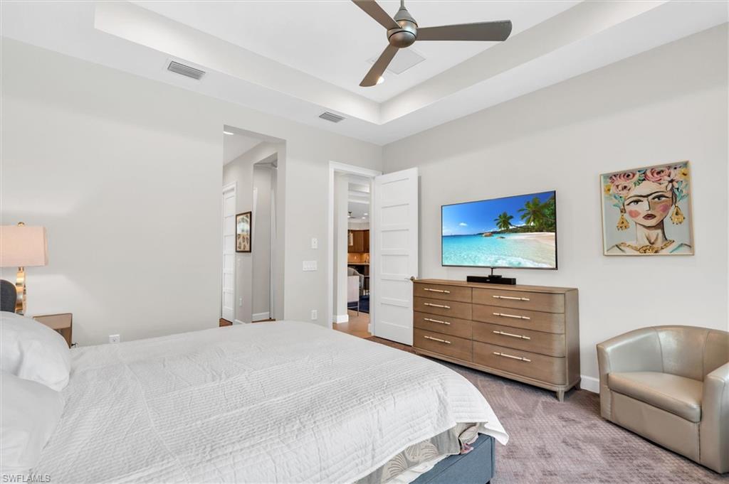 5769 Anegada Drive Naples, FL 34113 - Photo 21 of 45 a bedroom with a bed and a couch