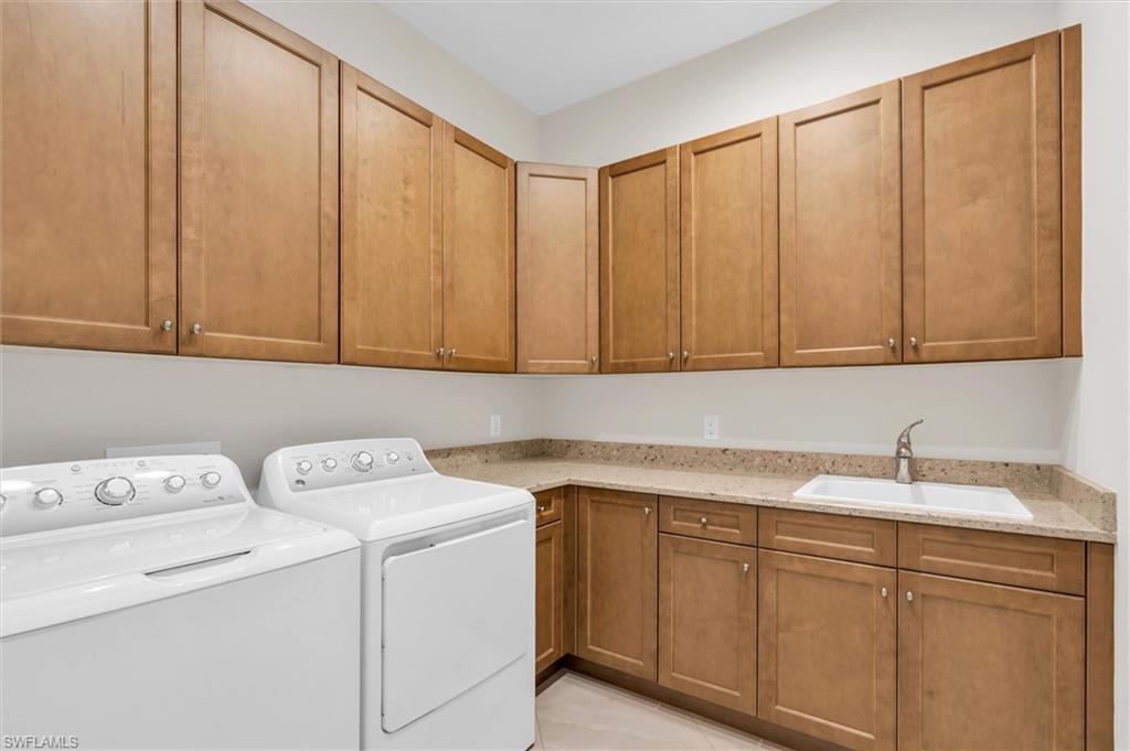 5769 Anegada Drive Naples, FL 34113 - Photo 25 of 45 a utility room with dryer and washer
