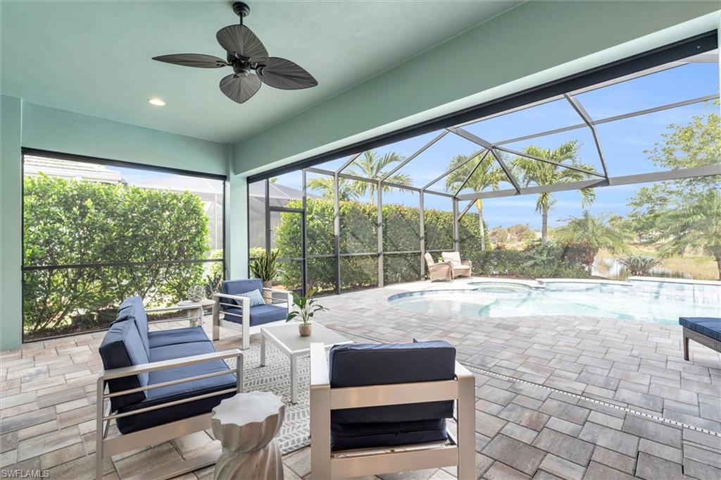 5769 Anegada Drive Naples, FL 34113 - Photo 26 of 45 a bedroom with furniture and large windows