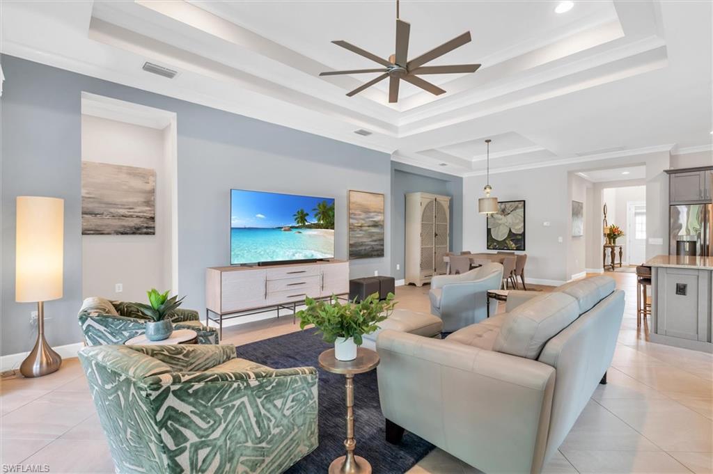 5769 Anegada Drive Naples, FL 34113 - Photo 7 of 45 a living room with furniture and a chandelier