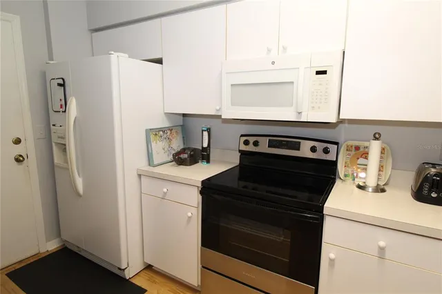 a kitchen with a stove and a refrigerator
