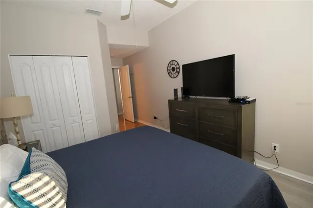 a bedroom with a bed and a flat screen tv
