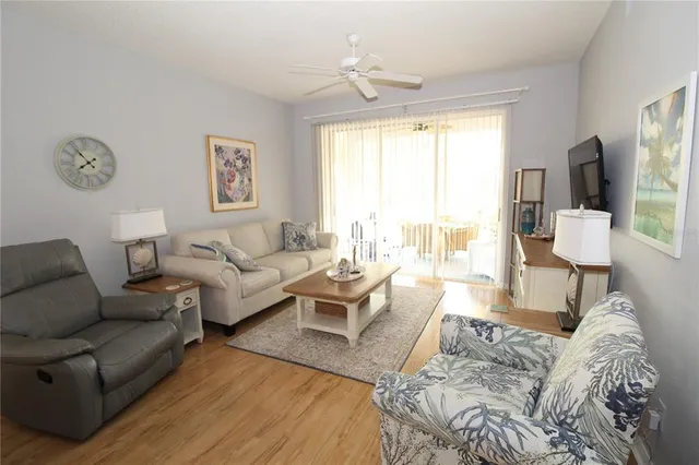 a living room with furniture wooden floor and a window
