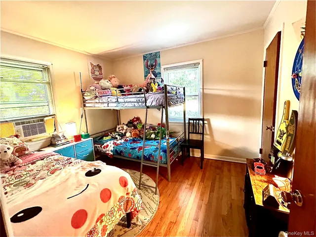 a bedroom with furniture and a flat screen tv