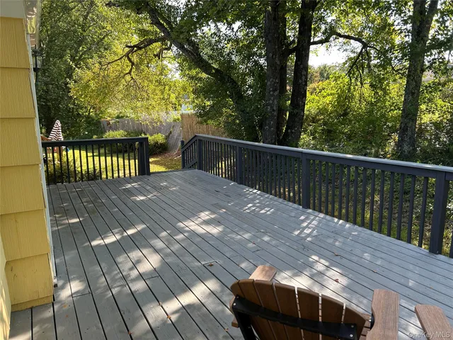 a view of balcony with wooden floor and fence