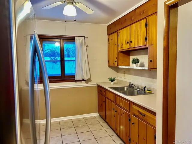 a kitchen with a sink and a refrigerator