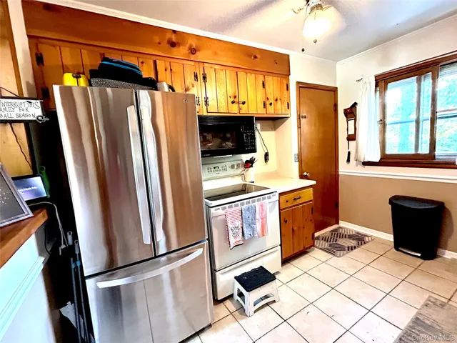 a kitchen with stainless steel appliances a refrigerator and a stove top oven