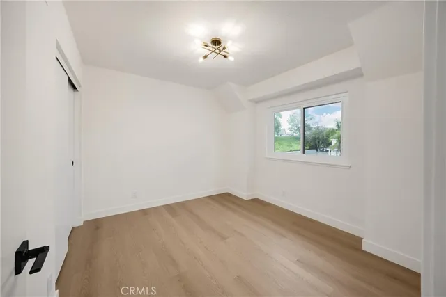a view of room with hardwood floor and ceiling fan