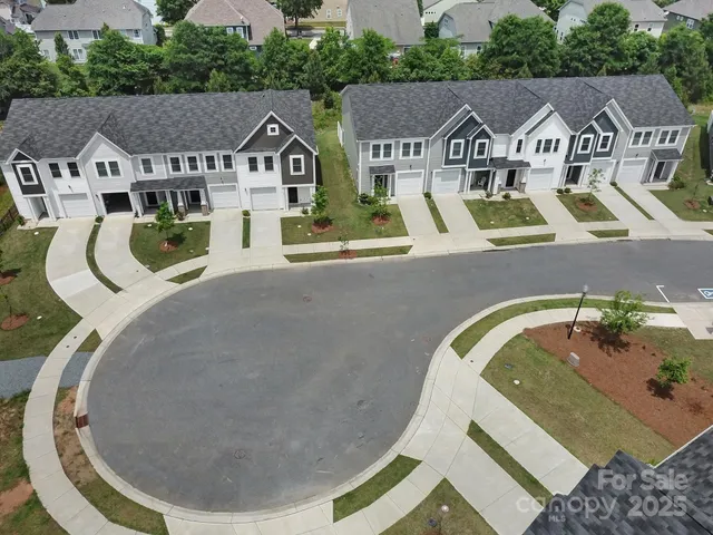 an aerial view of a house with swimming pool and garden