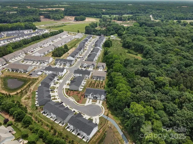 an aerial view of residential house with outdoor space and parking