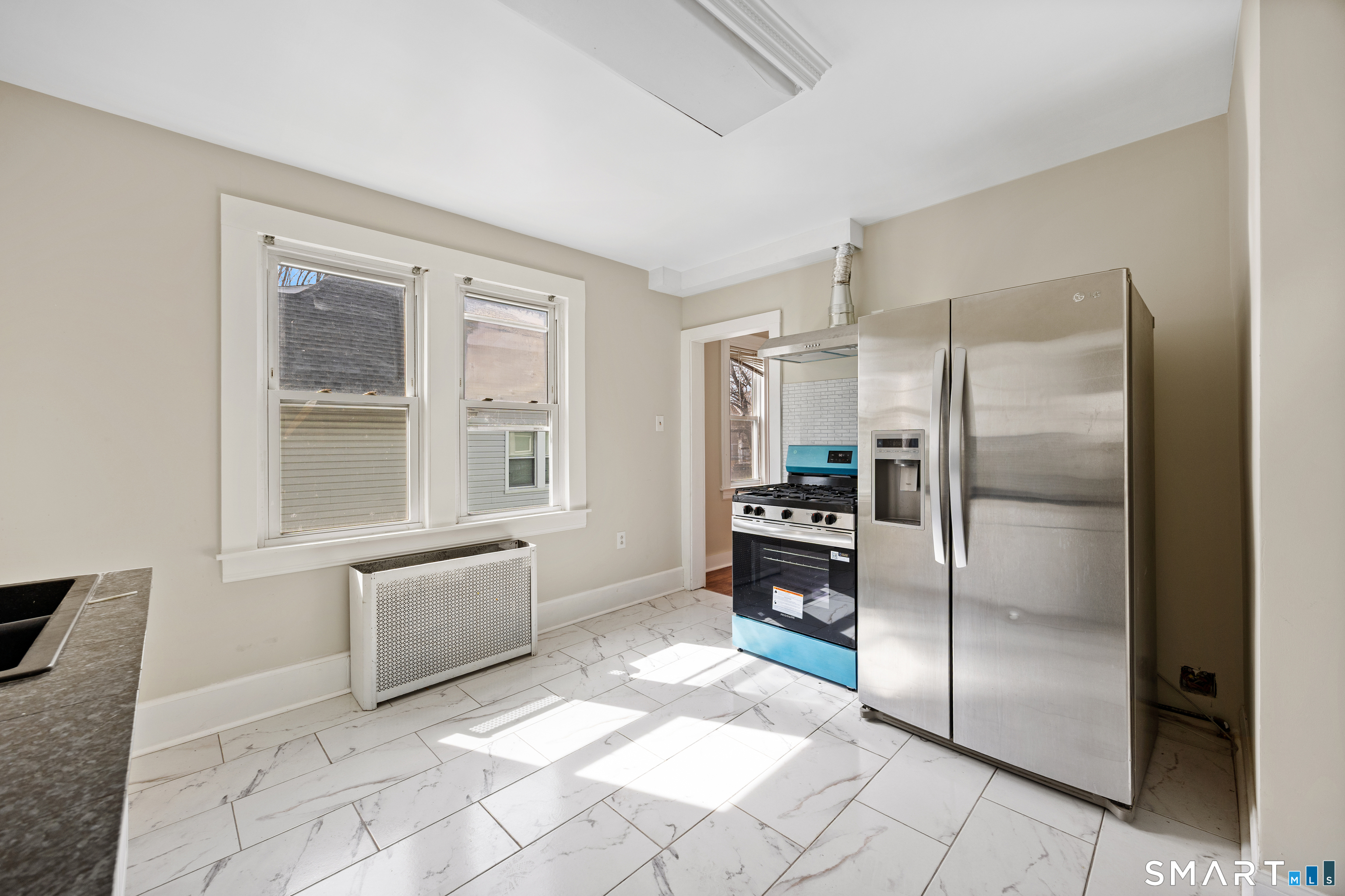 744 Park Street Bridgeport, CT 06608 - Photo 11 of 21 a kitchen with granite countertop a refrigerator and a cabinets