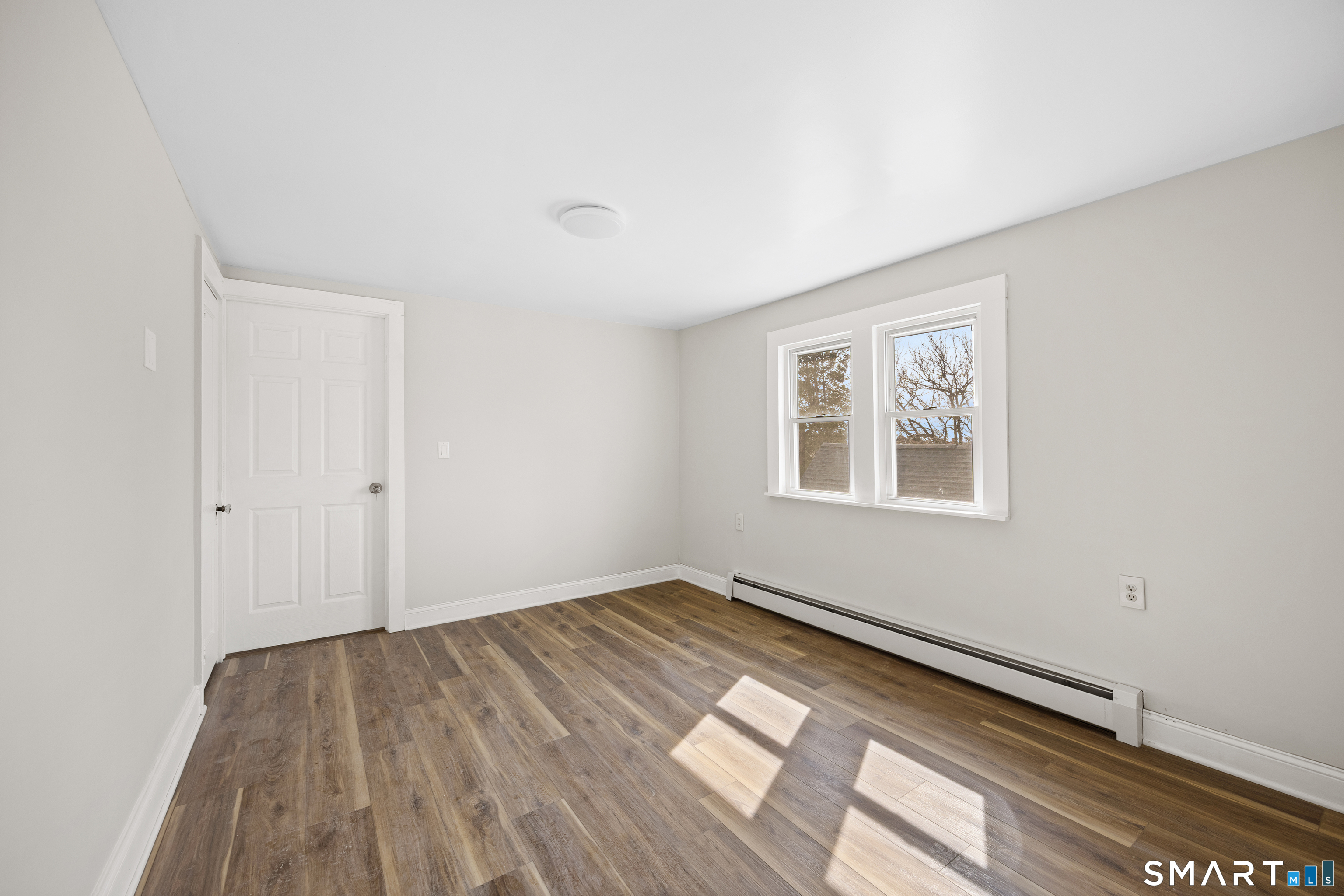 744 Park Street Bridgeport, CT 06608 - Photo 14 of 21 a view of a room with wooden floor and window