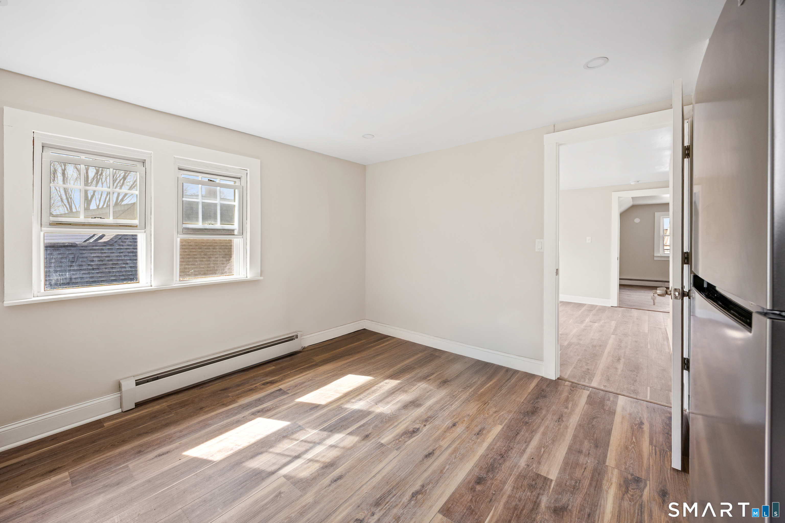 744 Park Street Bridgeport, CT 06608 - Photo 15 of 21 a view of an empty room with wooden floor and a window