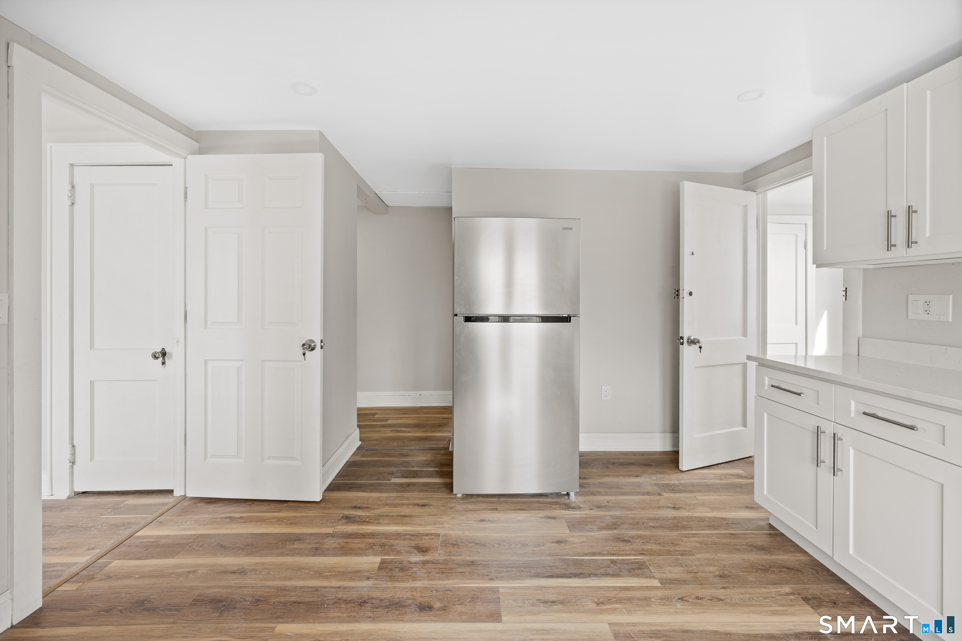 744 Park Street Bridgeport, CT 06608 - Photo 18 of 21 a view of a kitchen with white cabinets and refrigerator