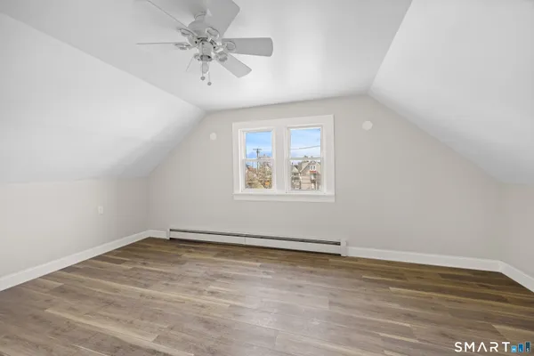 a view of an empty room and wooden floor