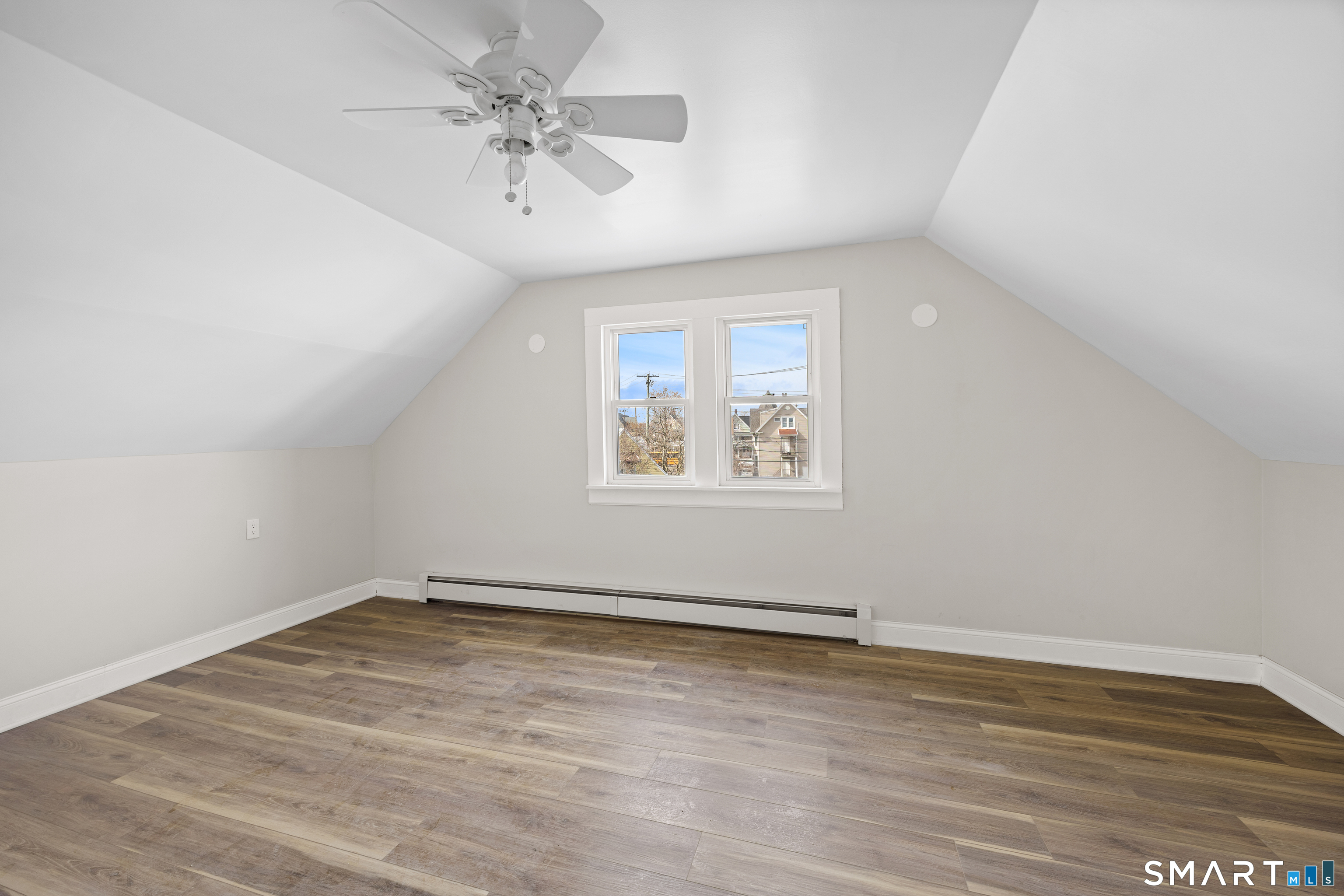 744 Park Street Bridgeport, CT 06608 - Photo 19 of 21 an empty room with wooden floor and windows