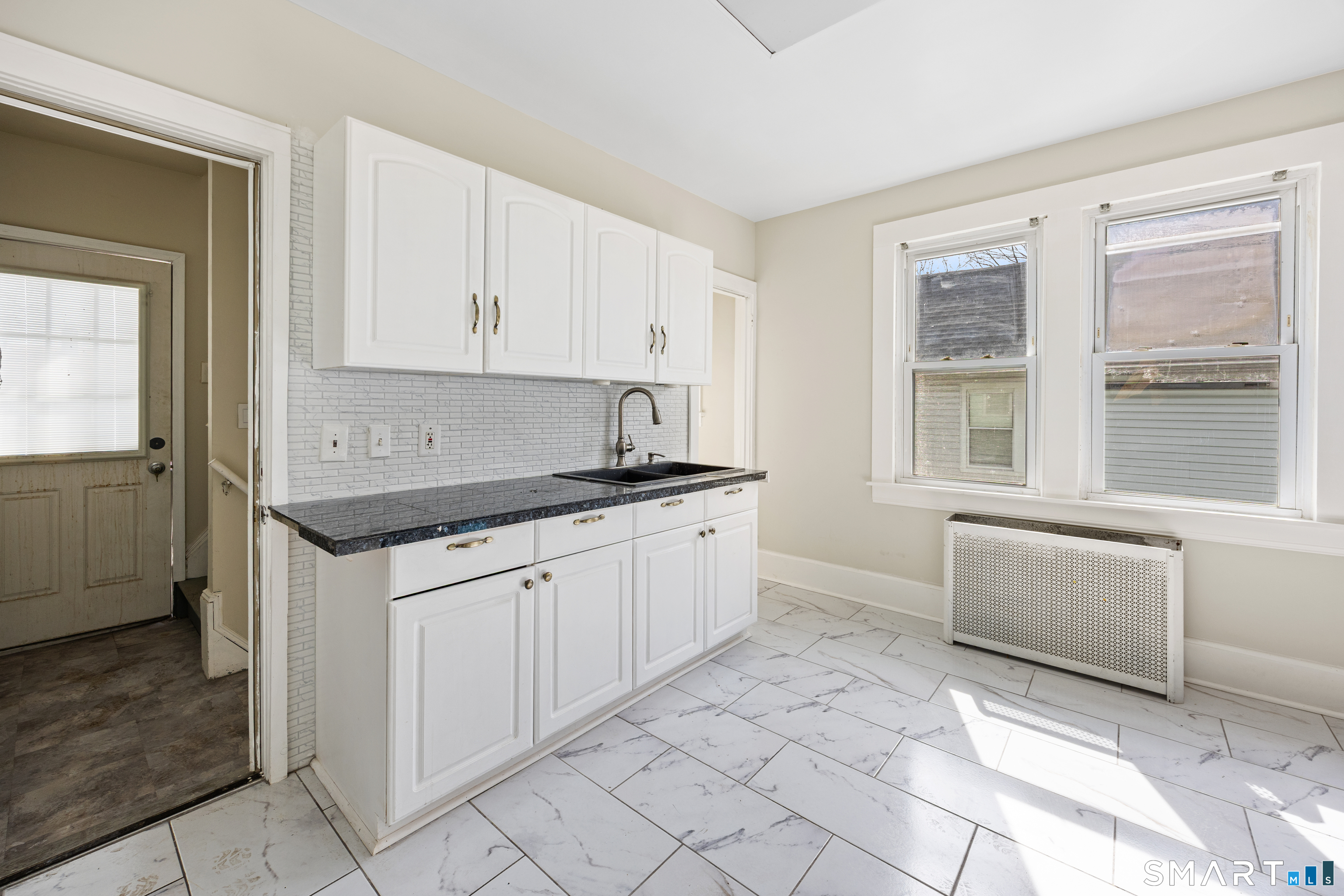 744 Park Street Bridgeport, CT 06608 - Photo 6 of 21 a kitchen with granite countertop a sink window and cabinets