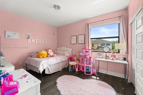 a bedroom with bed and a window