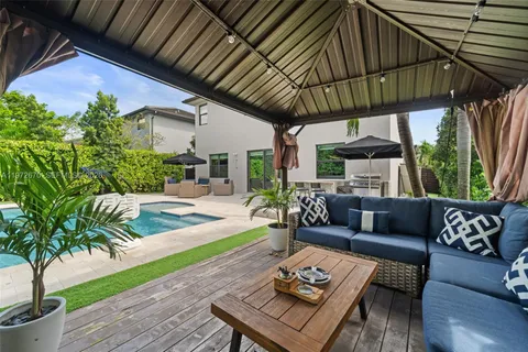 a outdoor living space with furniture potted plant and a large window