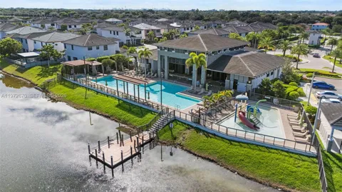 an aerial view of a house with a garden and lake view