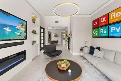 a living room with furniture a rug and a flat screen tv