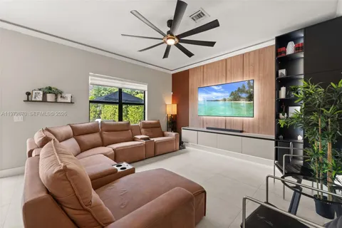 a living room with furniture a large window with a flat screen tv