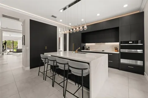 a kitchen with a table and chairs in it