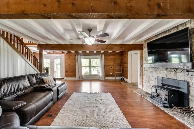 a bathroom with a granite countertop sink a mirror and a shower