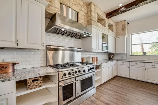 a view of a room with wooden floors and lots of windows