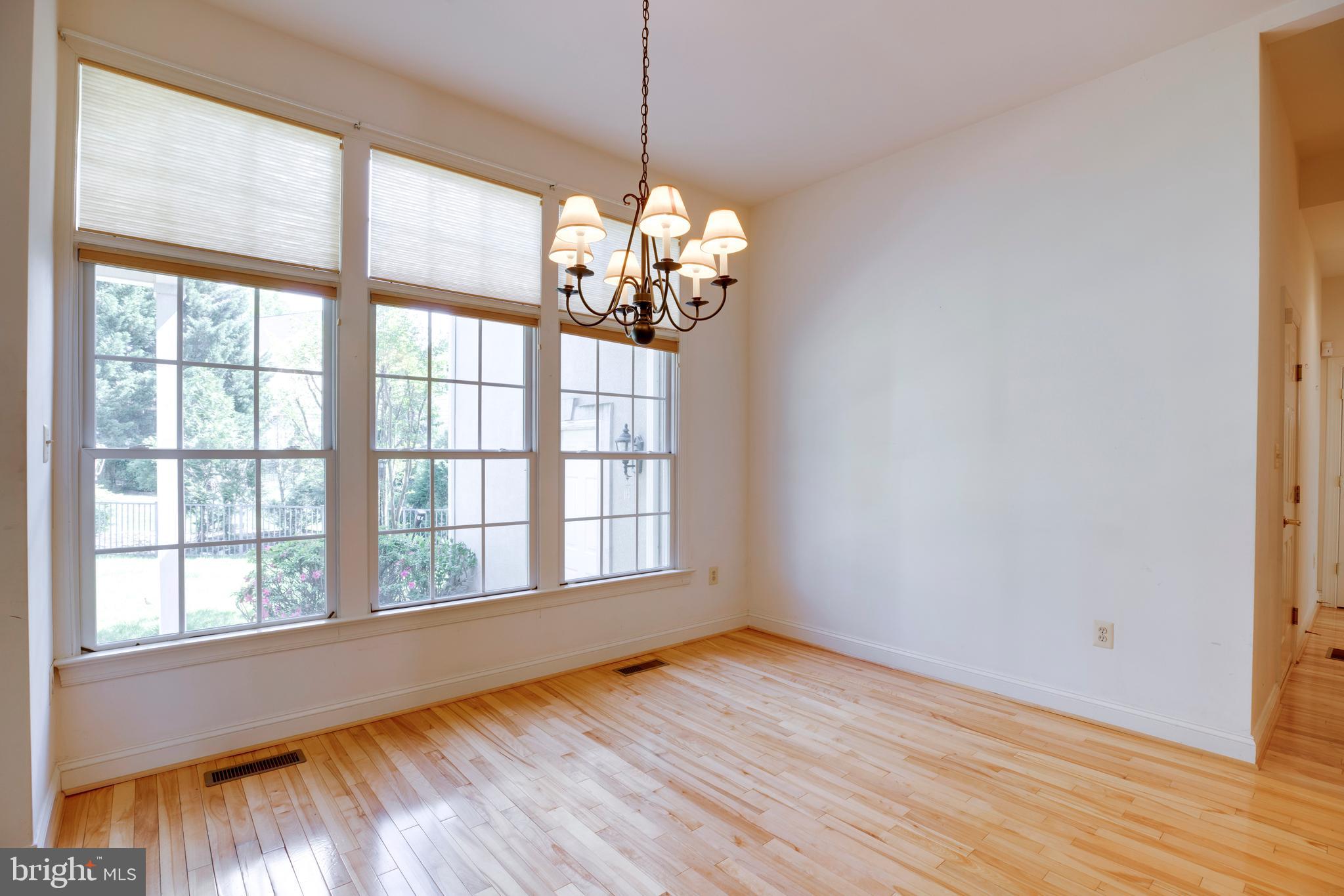 8277 Roxborough Loop Gainesville, VA 20155 - Photo 15 of 85 a view of a room with wooden floor and chandelier