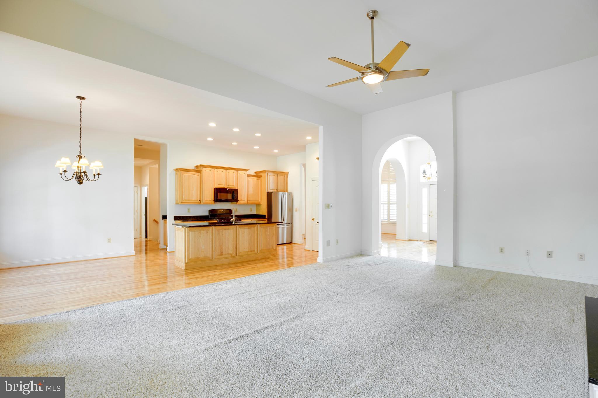 8277 Roxborough Loop Gainesville, VA 20155 - Photo 21 of 85 a view of a livingroom with a ceiling fan and kitchen view