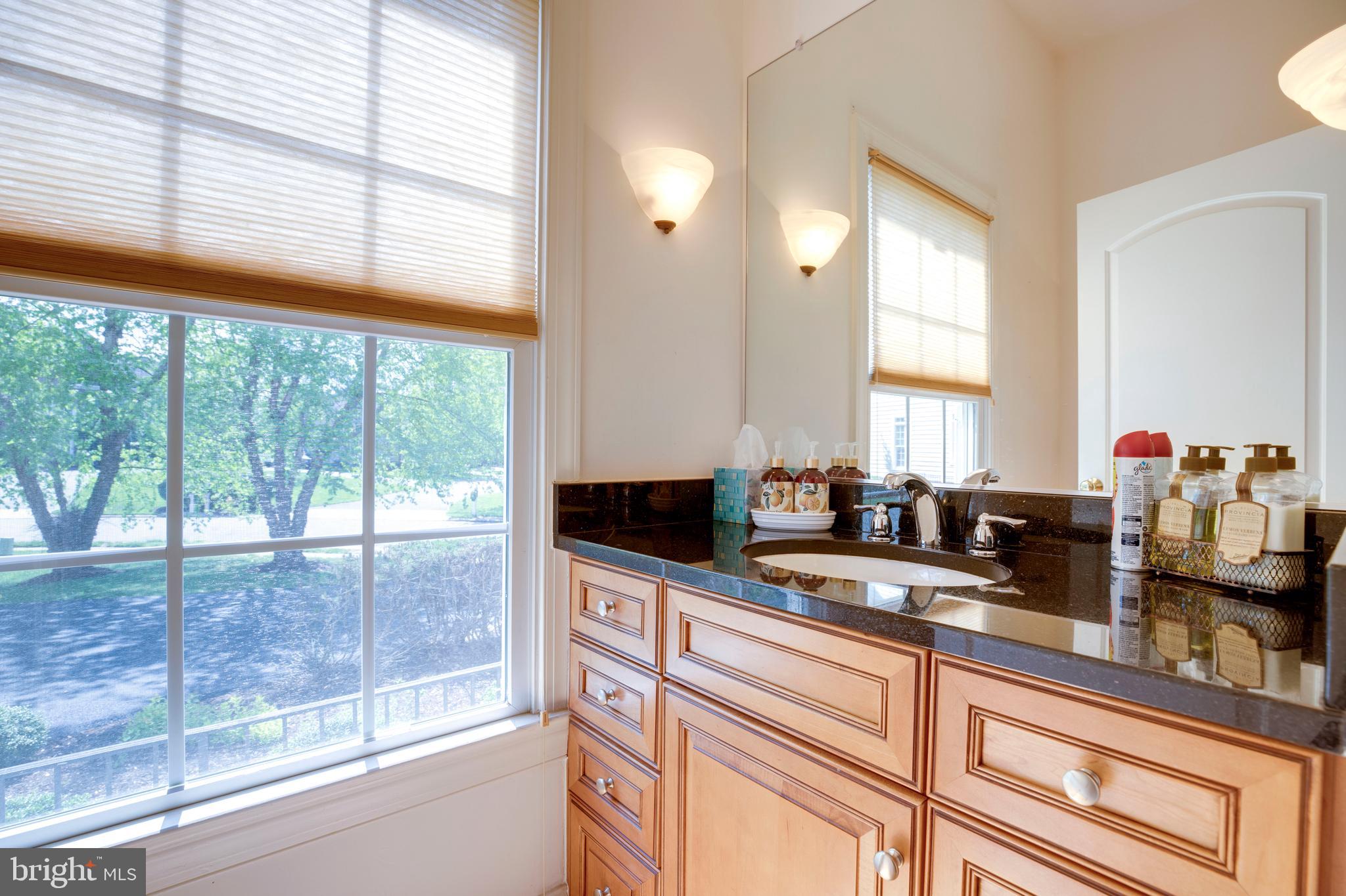 8277 Roxborough Loop Gainesville, VA 20155 - Photo 30 of 85 a kitchen with stainless steel appliances a sink and white cabinets