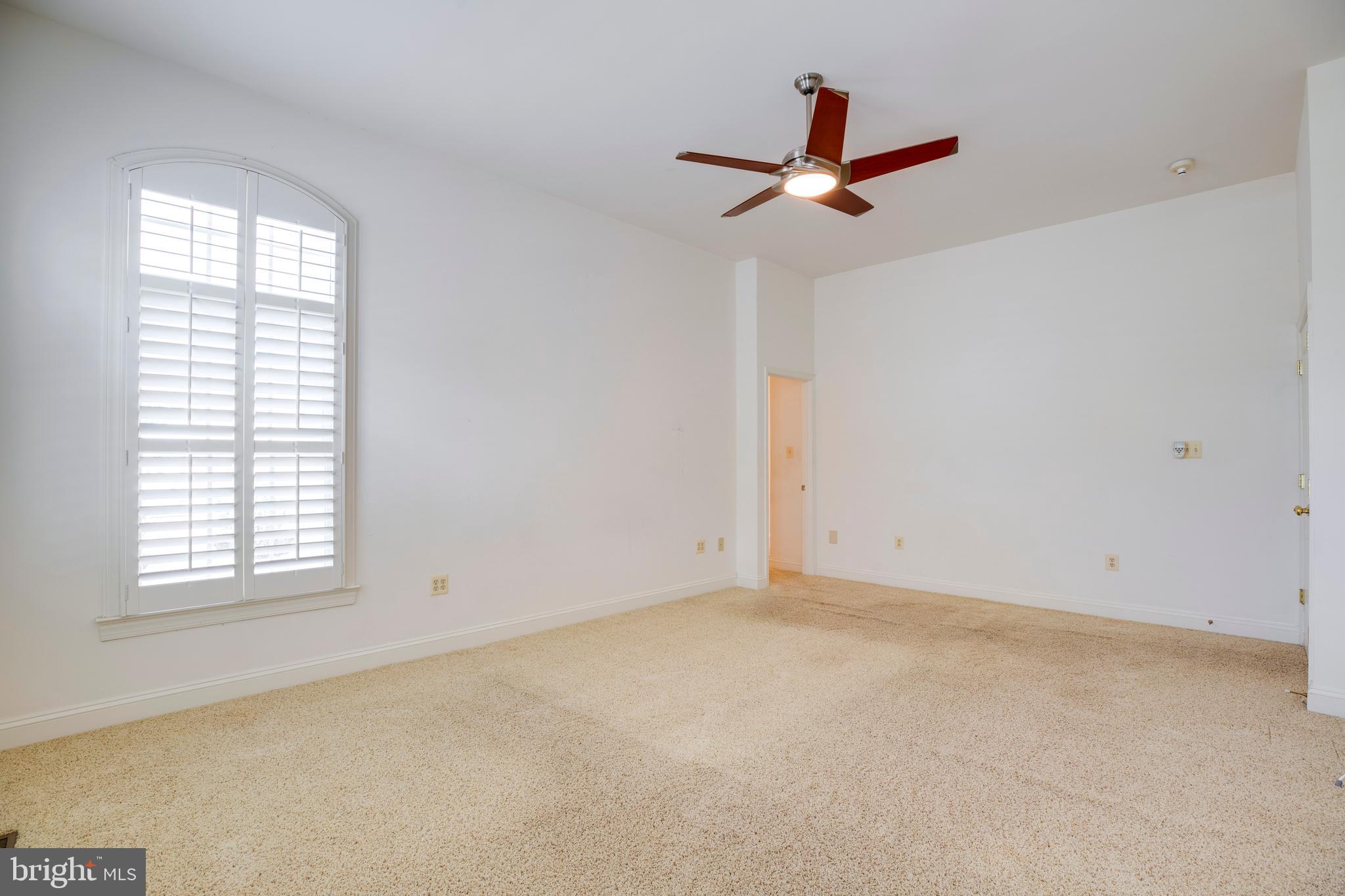 8277 Roxborough Loop Gainesville, VA 20155 - Photo 36 of 85 an empty room with ceiling fan and window