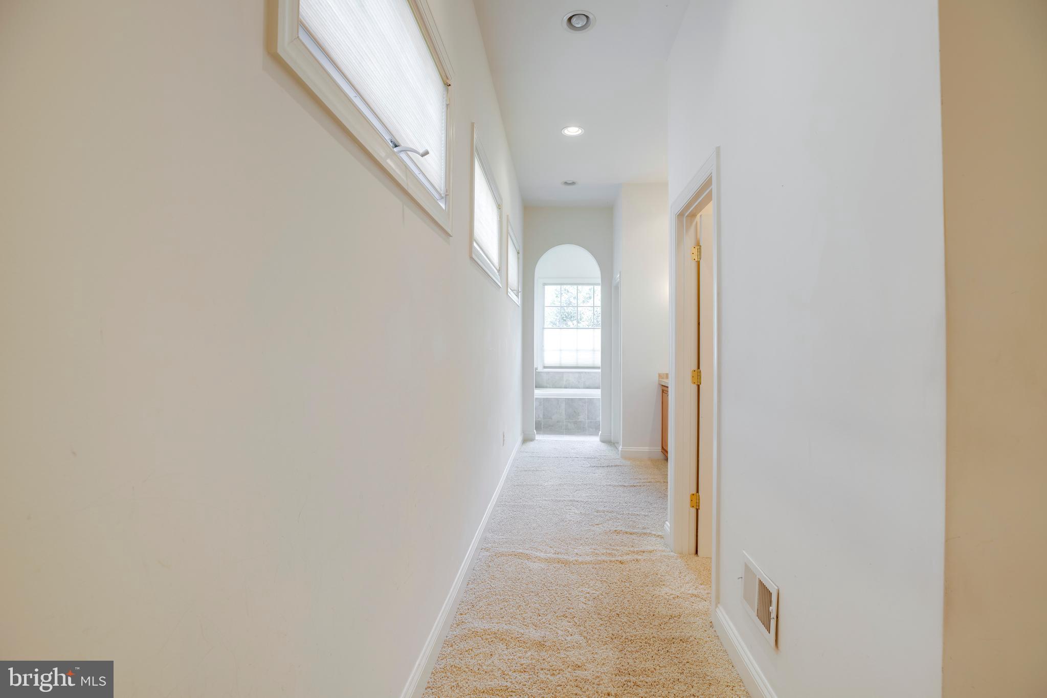 8277 Roxborough Loop Gainesville, VA 20155 - Photo 38 of 85 a view of a hallway with white walls