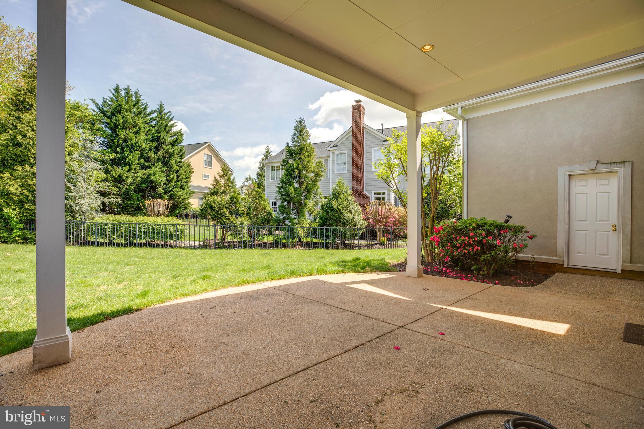 8277 Roxborough Loop Gainesville, VA 20155 - Photo 65 of 85 a view of a porch with furniture and garden