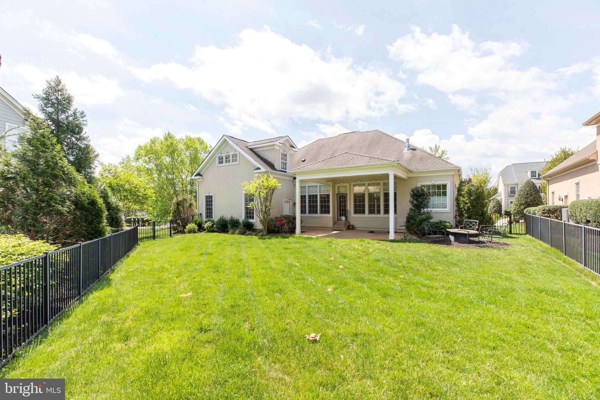 8277 Roxborough Loop Gainesville, VA 20155 - Photo 68 of 85 a view of a house with a yard and sitting area