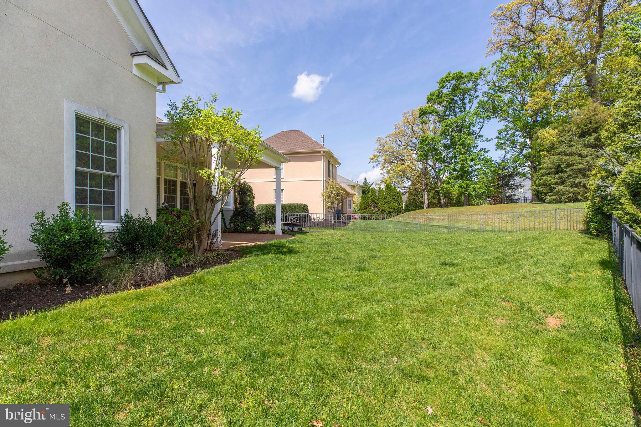 8277 Roxborough Loop Gainesville, VA 20155 - Photo 69 of 85 a view of a house with a big yard and palm trees