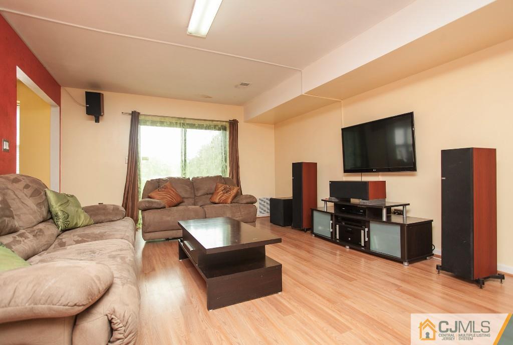 1525 Raspberry Court Edison, NJ 08817 - Photo 1 of 4 a living room with furniture and a flat screen tv
