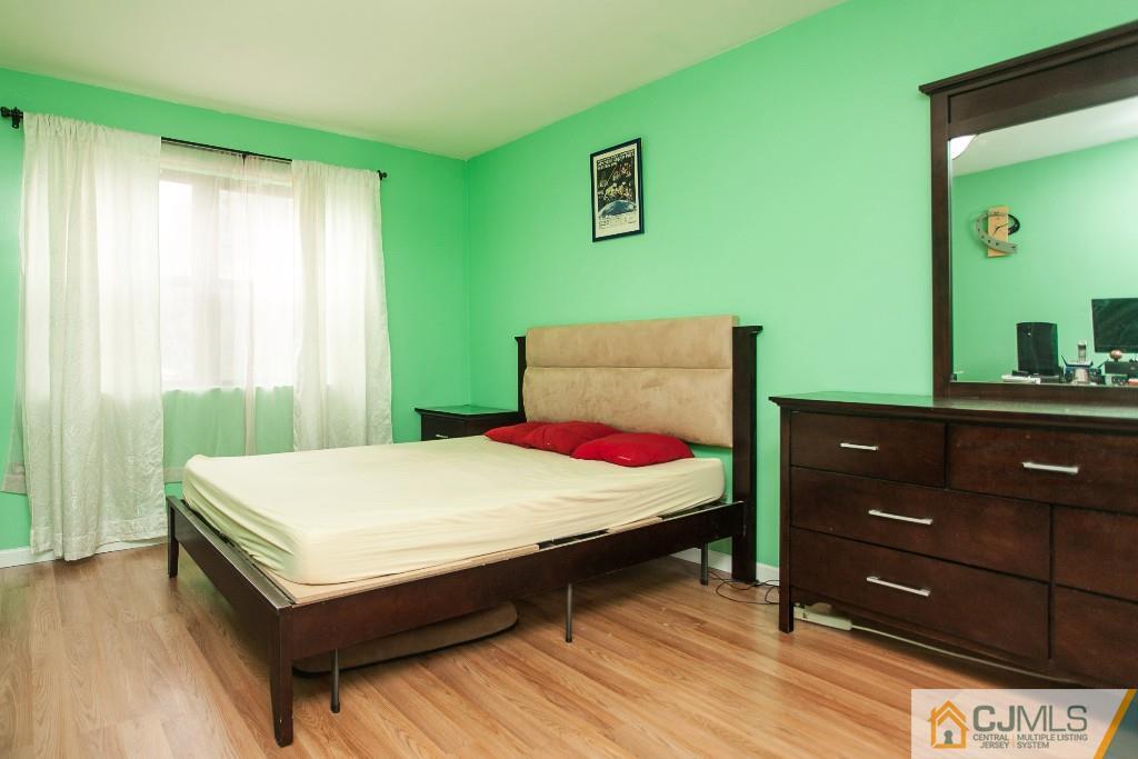 1525 Raspberry Court Edison, NJ 08817 - Photo 2 of 4 a room with a bed and a dresser