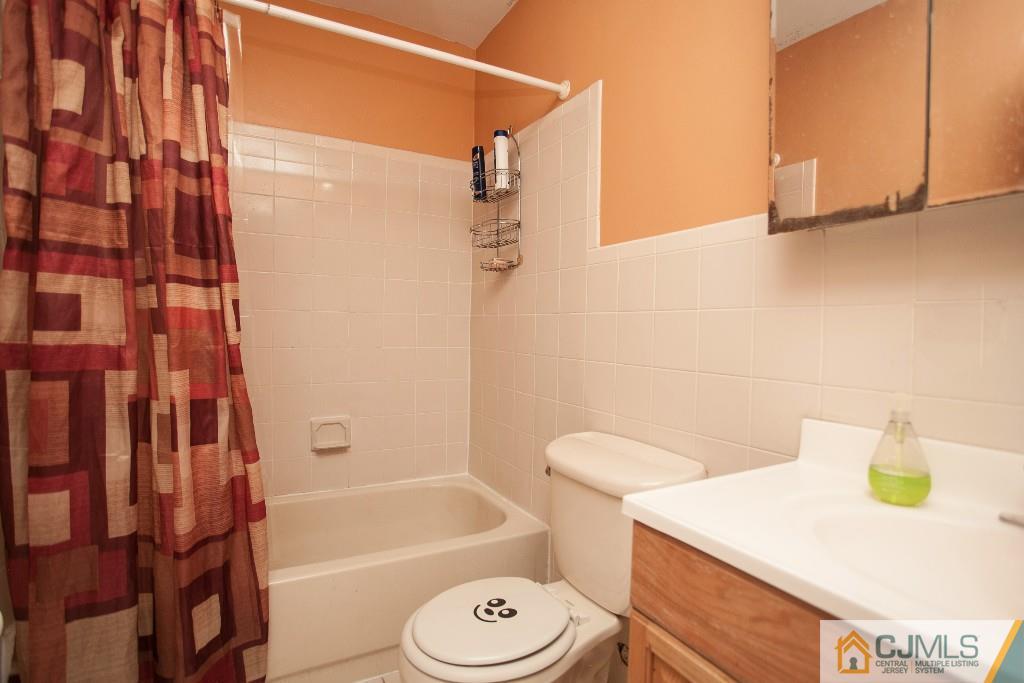 1525 Raspberry Court Edison, NJ 08817 - Photo 4 of 4 a bathroom with a sink a toilet and shower