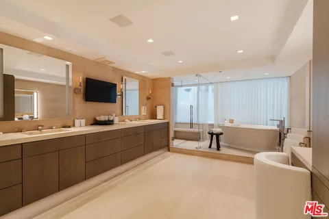 a bathroom with a tub sink and toilet