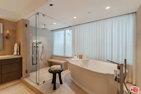 a bedroom with a bed and a large mirror