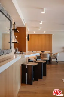 a kitchen with a sink and chairs