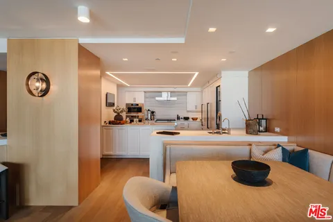 a kitchen with stainless steel appliances a sink stove and cabinets