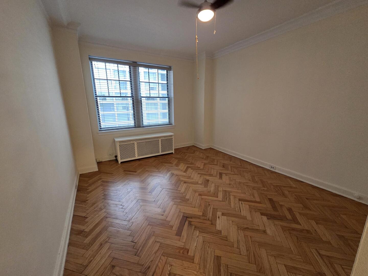 421 West Melrose Street, Unit 5D Chicago, IL 60657 - Photo 20 of 29 an empty room with wooden floor and windows