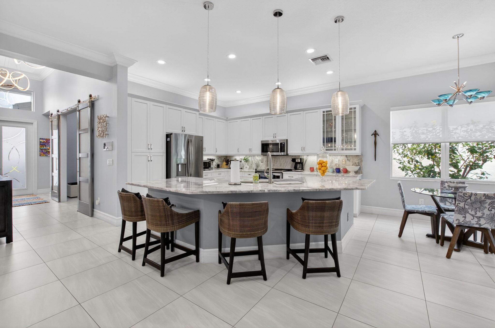 8263 Arabian Range Road Boynton Beach, FL 33473 - Photo 16 of 52 a kitchen with a dining table chairs and view kitchen