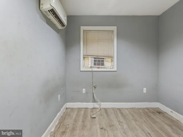 a view of a small space with wooden floor and a window